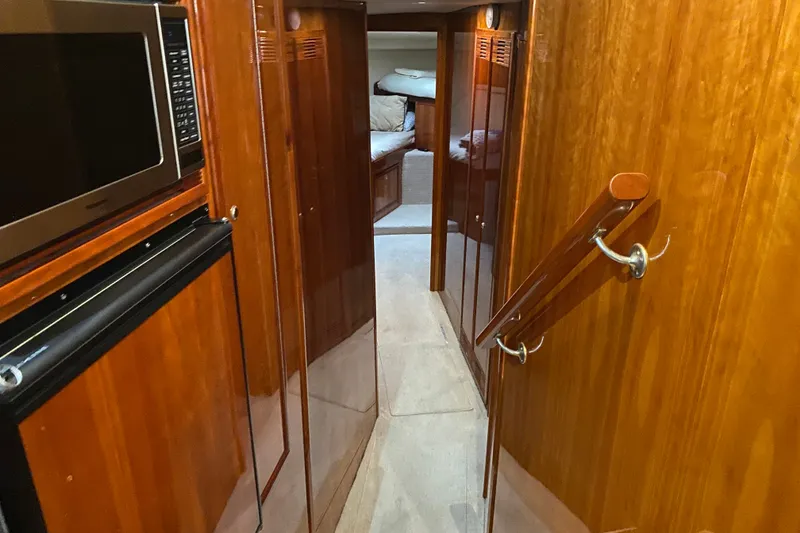 Slide: The Image of Interior view of 2005 Riviera 51 Flybridge yacht with wood paneling and modern amenities. - 15