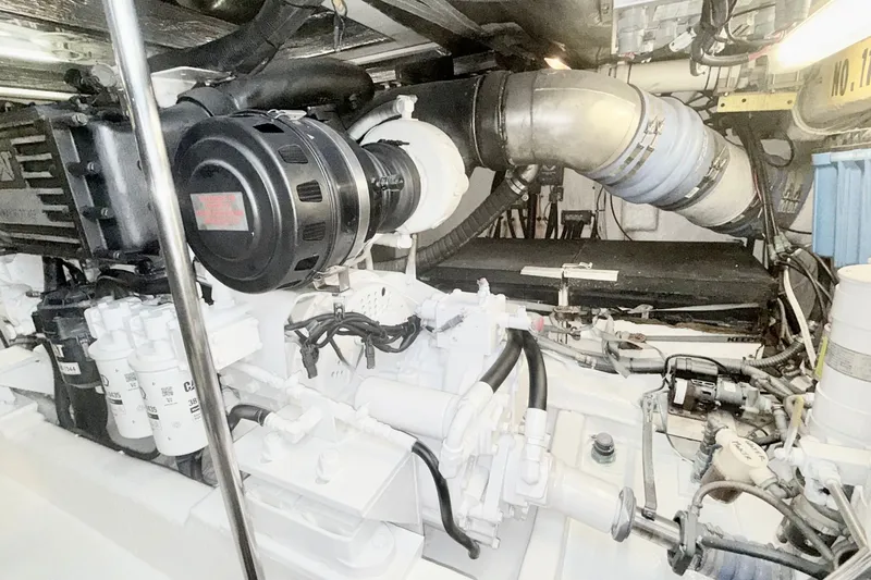 Slide: The Image of Engine room of a 2005 Riviera 51 Flybridge yacht, showcasing mechanical components. - 18