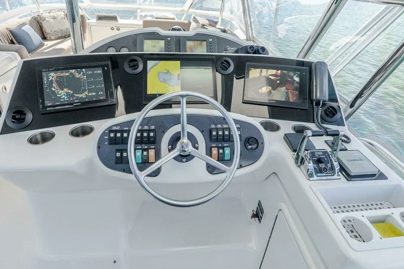 Slide: The Image of Cockpit of 2005 Riviera 51 Flybridge yacht with navigation screens and controls. - 10