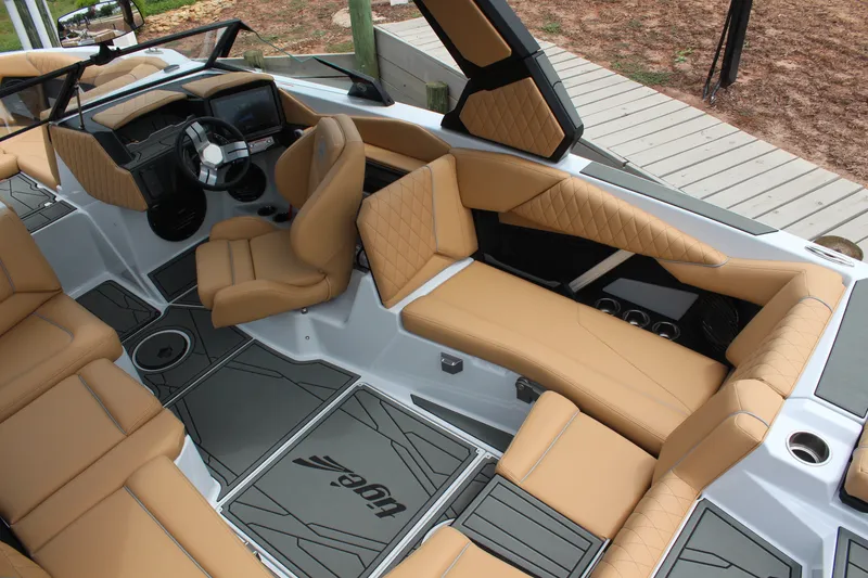 Slide: The Image of 2027 Tigé Z3 boat interior with tan leather seating and modern dashboard design. - 13