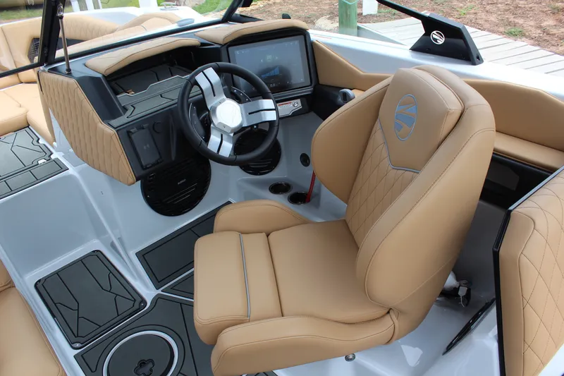 Slide: The Image of 2027 Tigé Z3 boat interior with tan leather seats and modern dashboard. - 14
