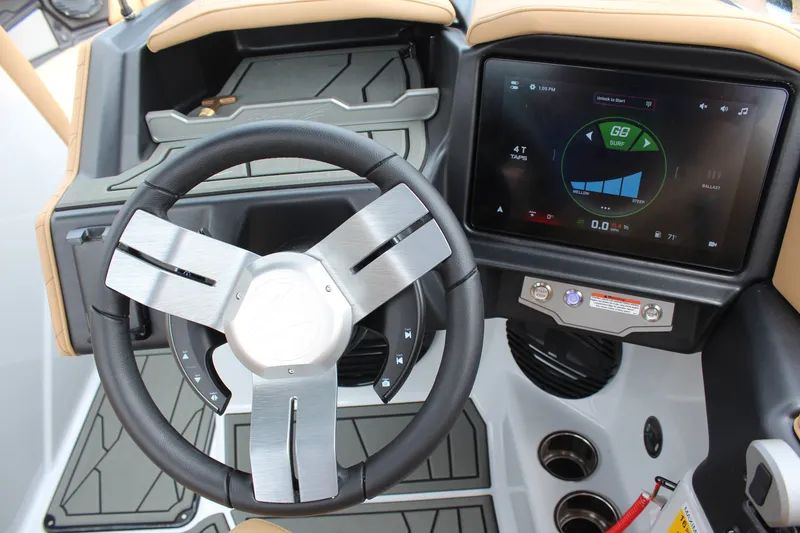 Slide: The Image of 2027 Tigé Z3 boat dashboard with modern steering wheel and touchscreen controls. - 15