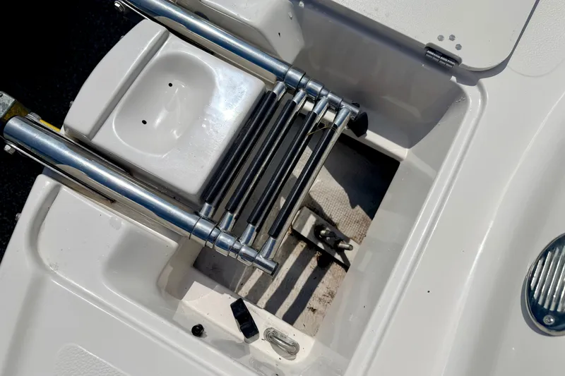 Slide: The Image of 2008 Starcraft Aurora Star Step 190 IO boat ladder and storage compartment. - 73