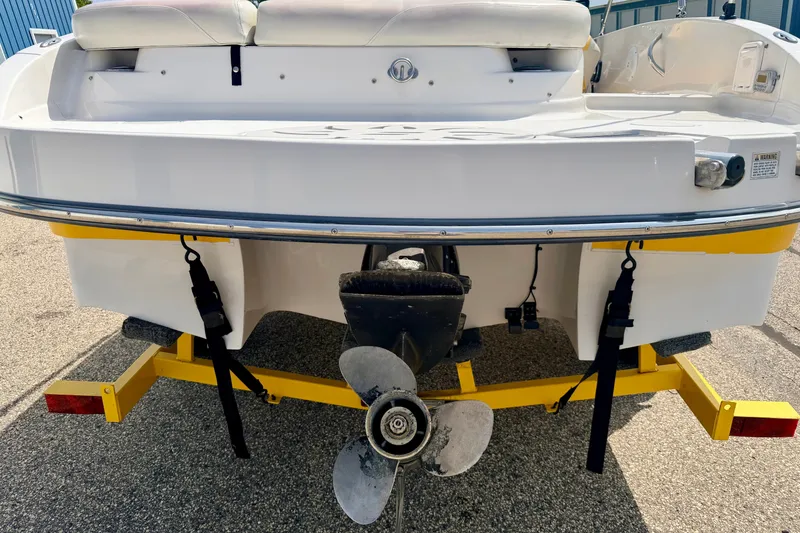 Slide: The Image of 2008 Starcraft Aurora Star Step 190 IO boat rear view with propeller and yellow trailer. - 21