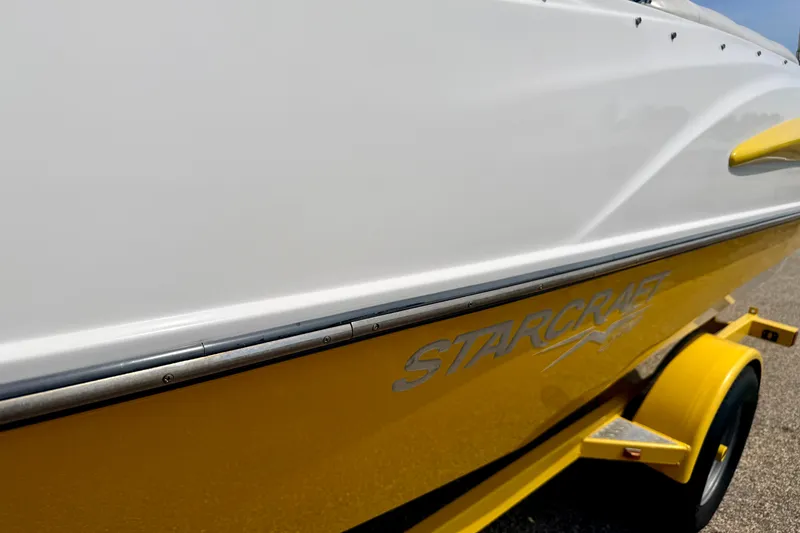 Slide: The Image of Yellow 2008 Starcraft Aurora Star Step 190 IO boat on trailer, close-up view. - 8