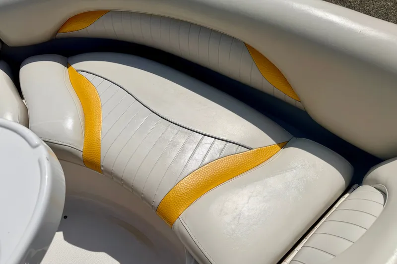 Slide: The Image of 2008 Starcraft Aurora Star Step 190 IO boat seating with white and yellow upholstery. - 46