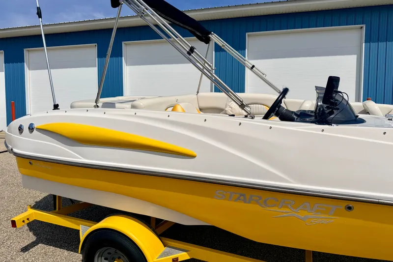 Slide: The Image of 2008 Starcraft Aurora Star Step 190 IO boat, yellow and white, on trailer. - 18