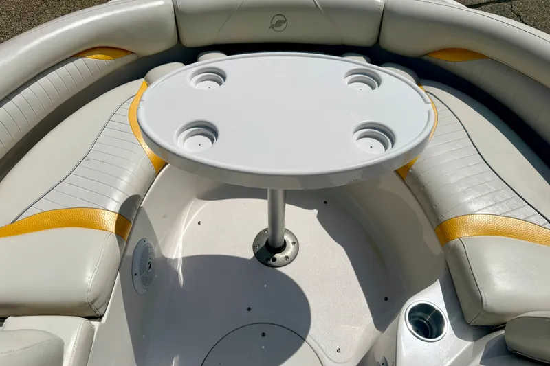 Slide: The Image of 2008 Starcraft Aurora Star Step 190 IO boat interior with round table and cushioned seating. - 50