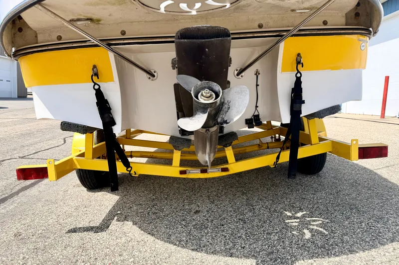Slide: The Image of Rear view of 2008 Starcraft Aurora Star Step 190 IO boat on yellow trailer. - 85