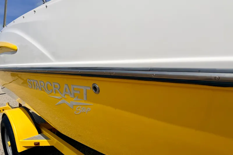 Slide: The Image of 2008 Starcraft Aurora Star Step 190 IO boat with yellow hull and trailer. - 16