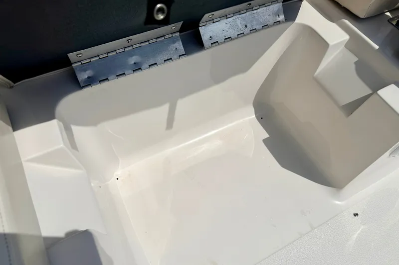 Slide: The Image of 2008 Starcraft Aurora Star Step 190 IO boat interior detail, featuring seating area and metal hinges. - 37
