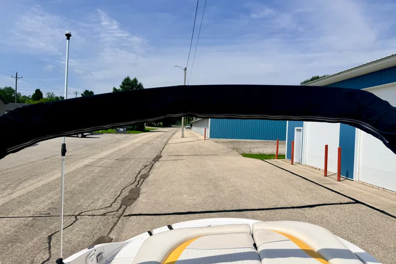 Slide: The Image of 2008 Starcraft Aurora Star Step 190 IO boat with bimini top on a sunny street. - 70