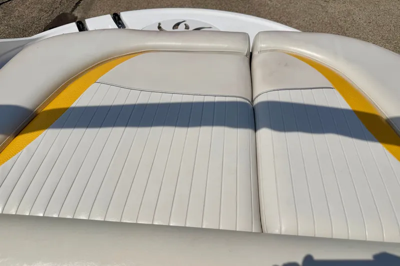Slide: The Image of 2008 Starcraft Aurora Star Step 190 IO boat seat with white and yellow upholstery. - 32