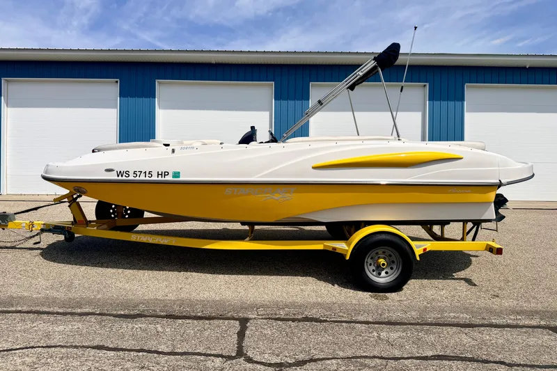 Slide: The Image of 2008 Starcraft Aurora Star Step 190 IO boat on trailer, parked outside blue building. - 5