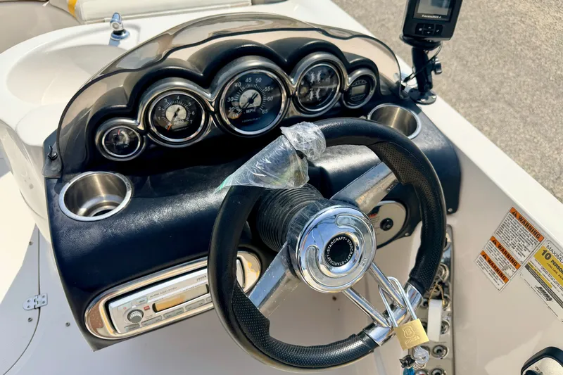 Slide: The Image of Dashboard of a 2008 Starcraft Aurora Star Step 190 IO boat with gauges and steering wheel. - 54