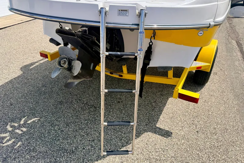Slide: The Image of Rear view of 2008 Starcraft Aurora Star Step 190 IO boat with ladder and trailer. - 24