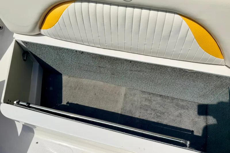 Slide: The Image of 2008 Starcraft Aurora Star Step 190 IO boat storage compartment with white and yellow upholstery. - 35
