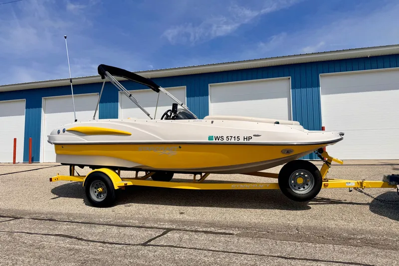 Slide: The Image of 2008 Starcraft Aurora Star Step 190 IO boat on yellow trailer, parked outdoors. - 4