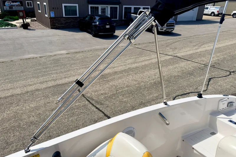 Slide: The Image of 2008 Starcraft Aurora Star Step 190 IO boat with bimini top frame, parked near buildings. - 71