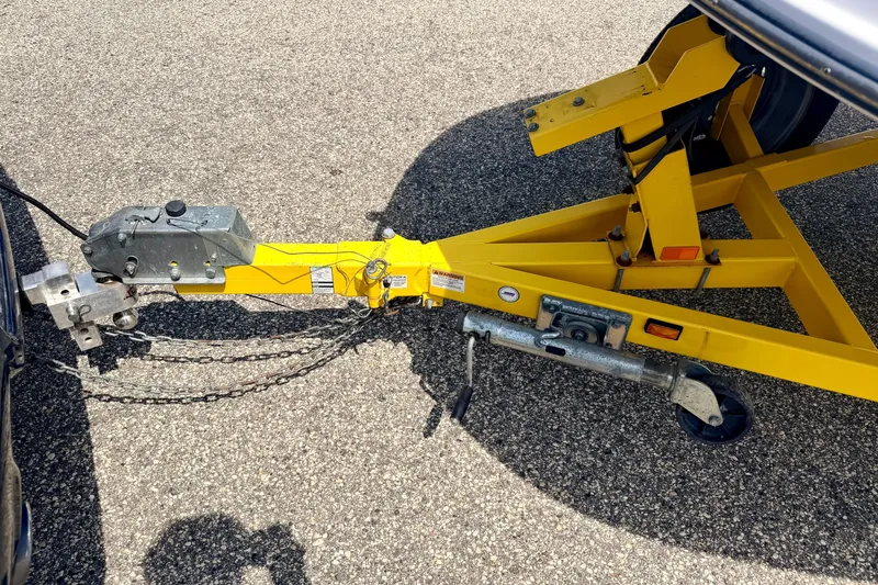 Slide: The Image of Yellow trailer hitch of 2008 Starcraft Aurora Star Step 190 IO on asphalt surface. - 82