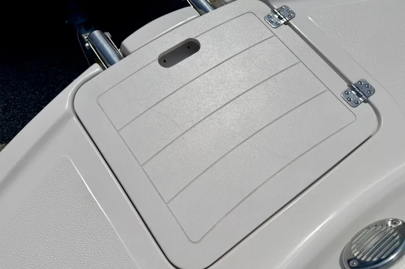 Slide: The Image of 2008 Starcraft Aurora Star Step 190 IO boat hatch with textured surface and metal hinges. - 72