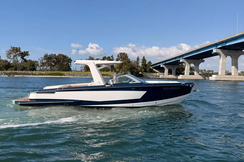 Slide: The Image of 2022 Aviara AV32 I/O boat cruising near a bridge on a sunny day. - 36