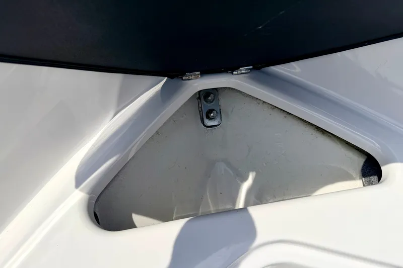 Slide: The Image of Storage compartment on a 2014 Four Winns H200 boat, featuring a hinged lid. - 70