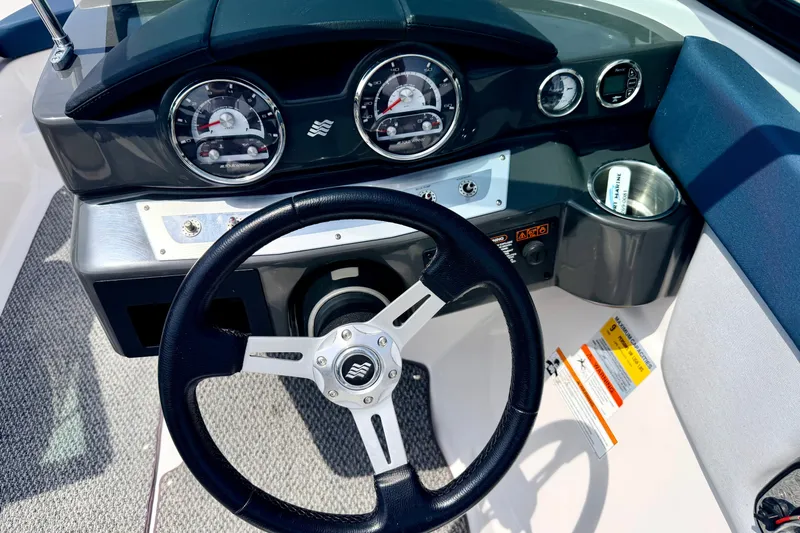 Slide: The Image of Dashboard of 2014 Four Winns H200 boat with steering wheel and gauges. - 52