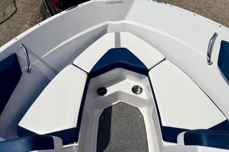 Slide: The Image of 2014 Four Winns H200 boat interior with blue and white seating and stainless steel cup holder. - 66