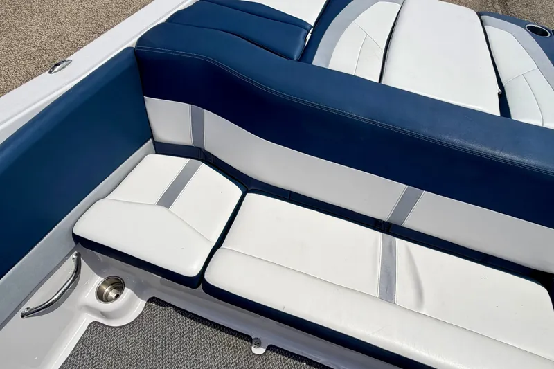 Slide: The Image of 2014 Four Winns H200 boat interior with blue and white cushioned seating. - 31