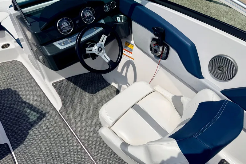 Slide: The Image of Interior of 2014 Four Winns H200 boat with steering wheel and dashboard controls. - 51