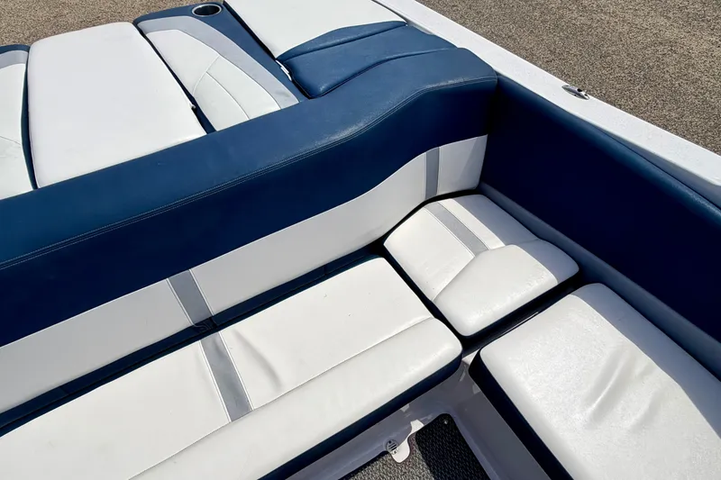 Slide: The Image of 2014 Four Winns H200 boat interior with blue and white cushioned seating. - 32