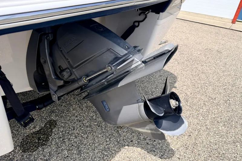 Slide: The Image of 2014 Four Winns H200 boat outboard motor and propeller on pavement. - 19