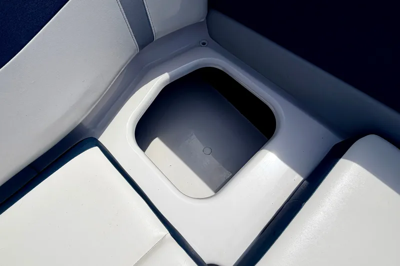 Slide: The Image of Storage compartment in 2014 Four Winns H200 boat, featuring white and blue seating. - 42