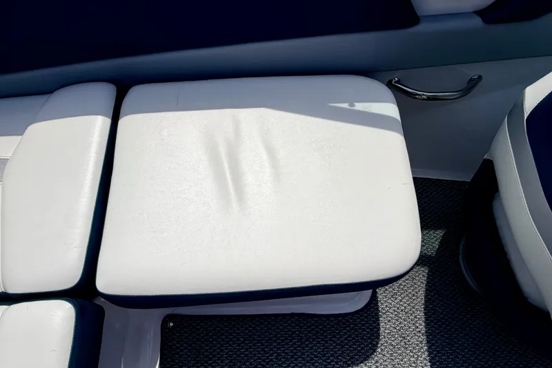 Slide: The Image of White cushioned seating on a 2014 Four Winns H200 boat interior. - 43