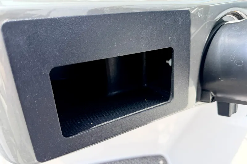 Slide: The Image of Storage compartment on a 2014 Four Winns H200 boat dashboard. - 57