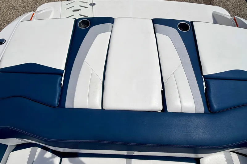 Slide: The Image of 2014 Four Winns H200 boat seating with blue and white upholstery. - 29