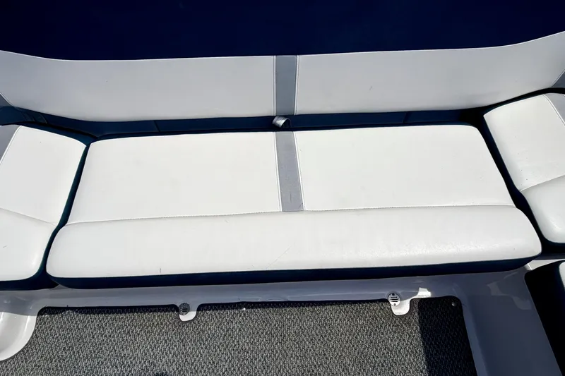 Slide: The Image of White seating on 2014 Four Winns H200 boat, featuring clean upholstery and carpeted flooring. - 39