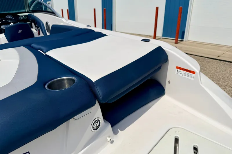 Slide: The Image of 2014 Four Winns H200 boat interior with blue and white seating and cup holder. - 25