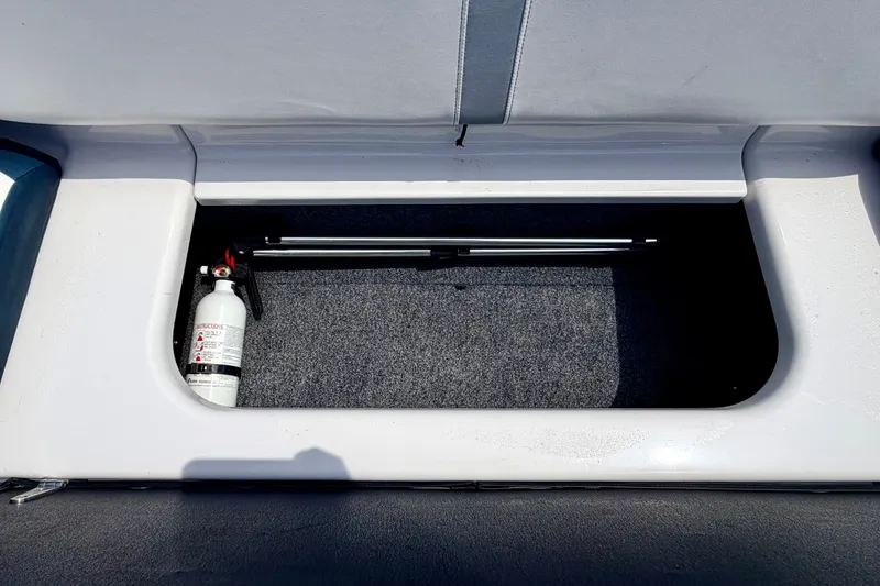Slide: The Image of Storage compartment in a 2014 Four Winns H200 boat with a fire extinguisher. - 40