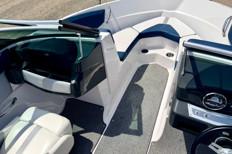 Slide: The Image of Interior of 2014 Four Winns H200 boat, featuring seating and dashboard details. - 77