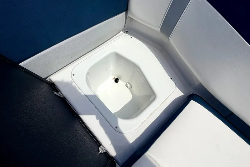 Slide: The Image of 2014 Four Winns H200 boat interior storage compartment with white and blue seating. - 38