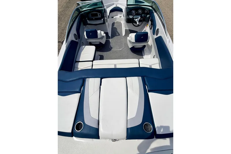 Slide: The Image of 2014 Four Winns H200 boat interior with blue and white seating and modern dashboard. - 28