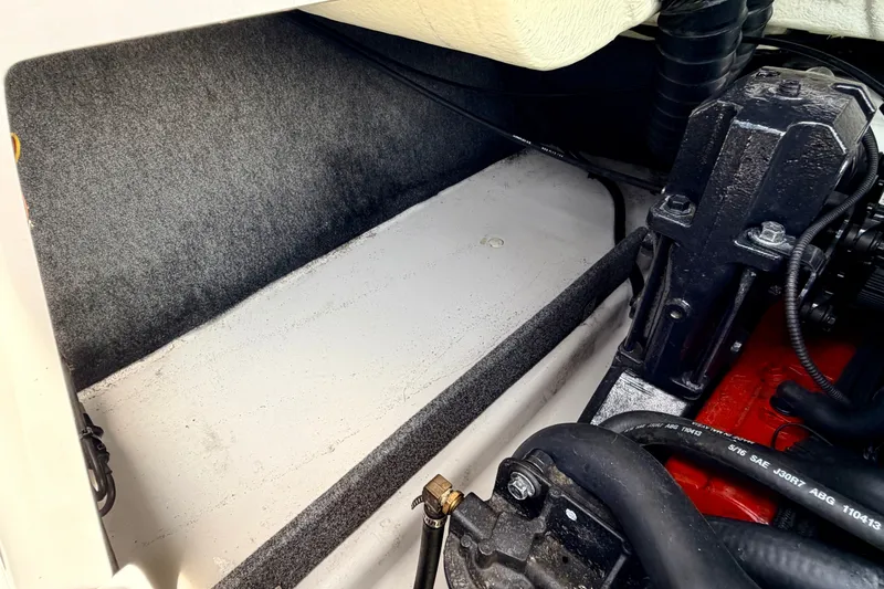 Slide: The Image of Engine compartment of a 2014 Four Winns H200 boat, showcasing mechanical components. - 35