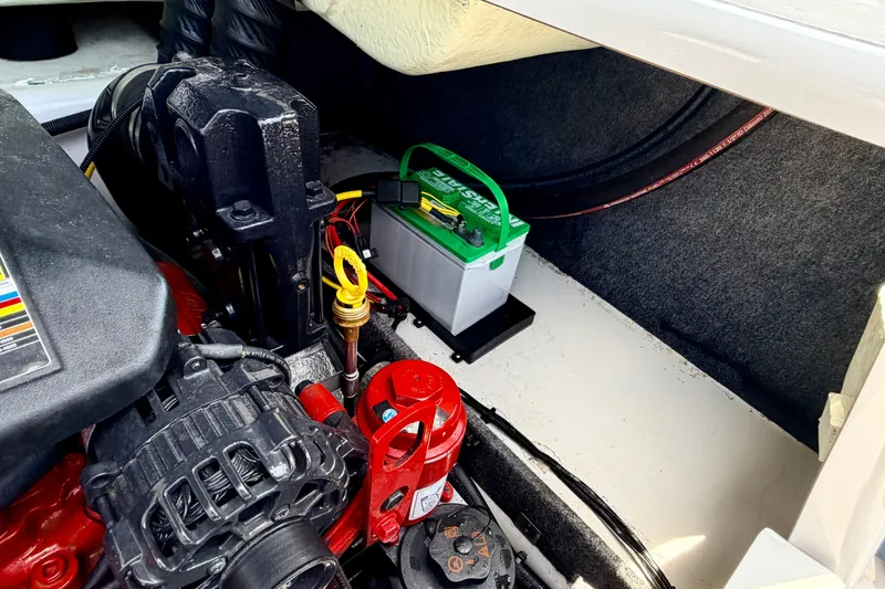 Slide: The Image of Engine compartment of 2014 Four Winns H200 boat with battery and mechanical components. - 34