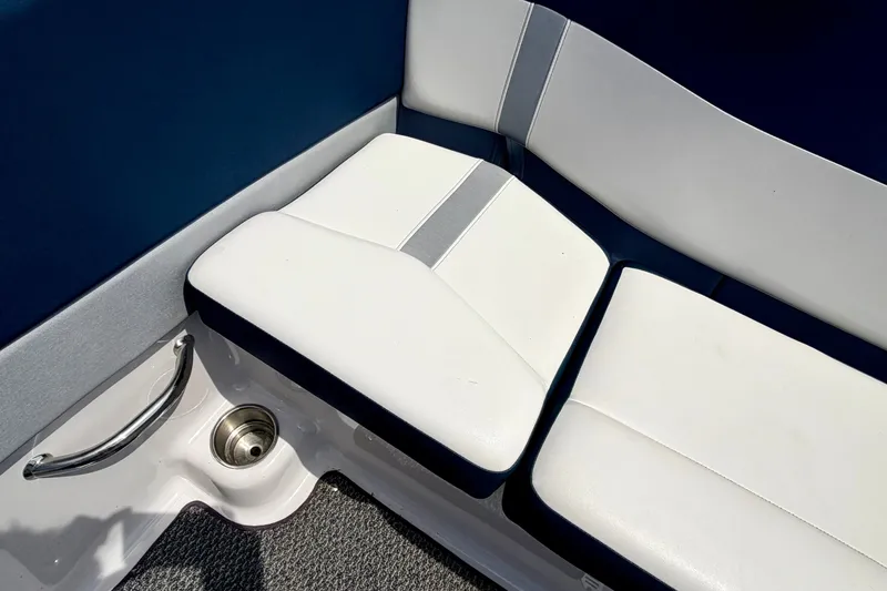 Slide: The Image of White and blue seating on 2014 Four Winns H200 boat, featuring sleek design and cup holder. - 37