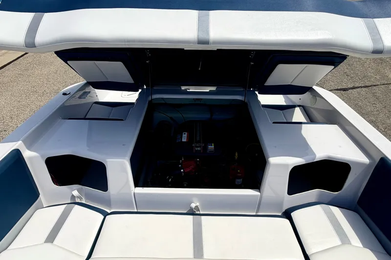 Slide: The Image of 2014 Four Winns H200 boat engine compartment with open hatches, showcasing interior details. - 36