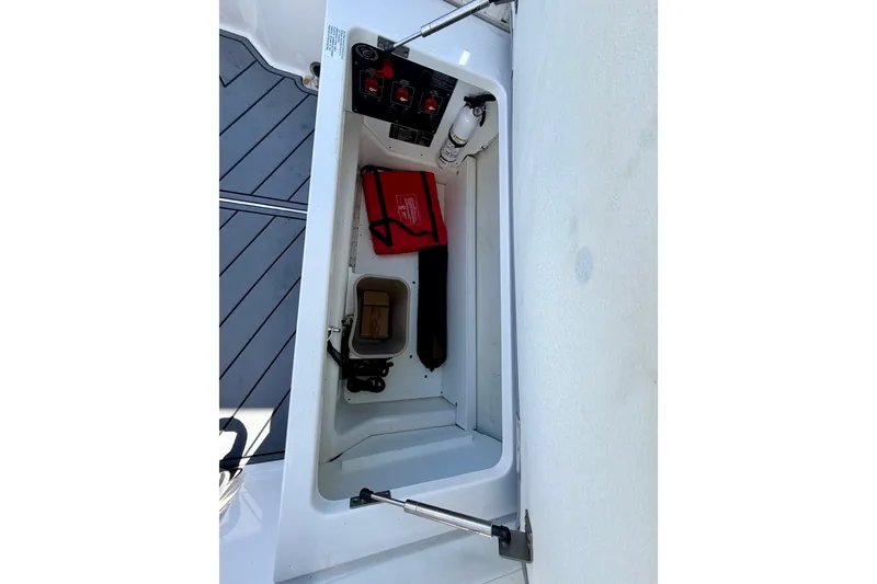 Slide: The Image of Storage compartment of 2022 Cobalt R8 Outboard boat with safety equipment and fire extinguisher. - 33
