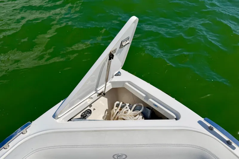 Slide: The Image of Open storage compartment on 2022 Cobalt R8 Outboard boat with ropes inside. - 35