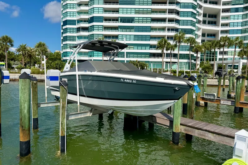 Slide: The Image of 2022 Cobalt R8 Outboard boat docked near modern waterfront building. - 38